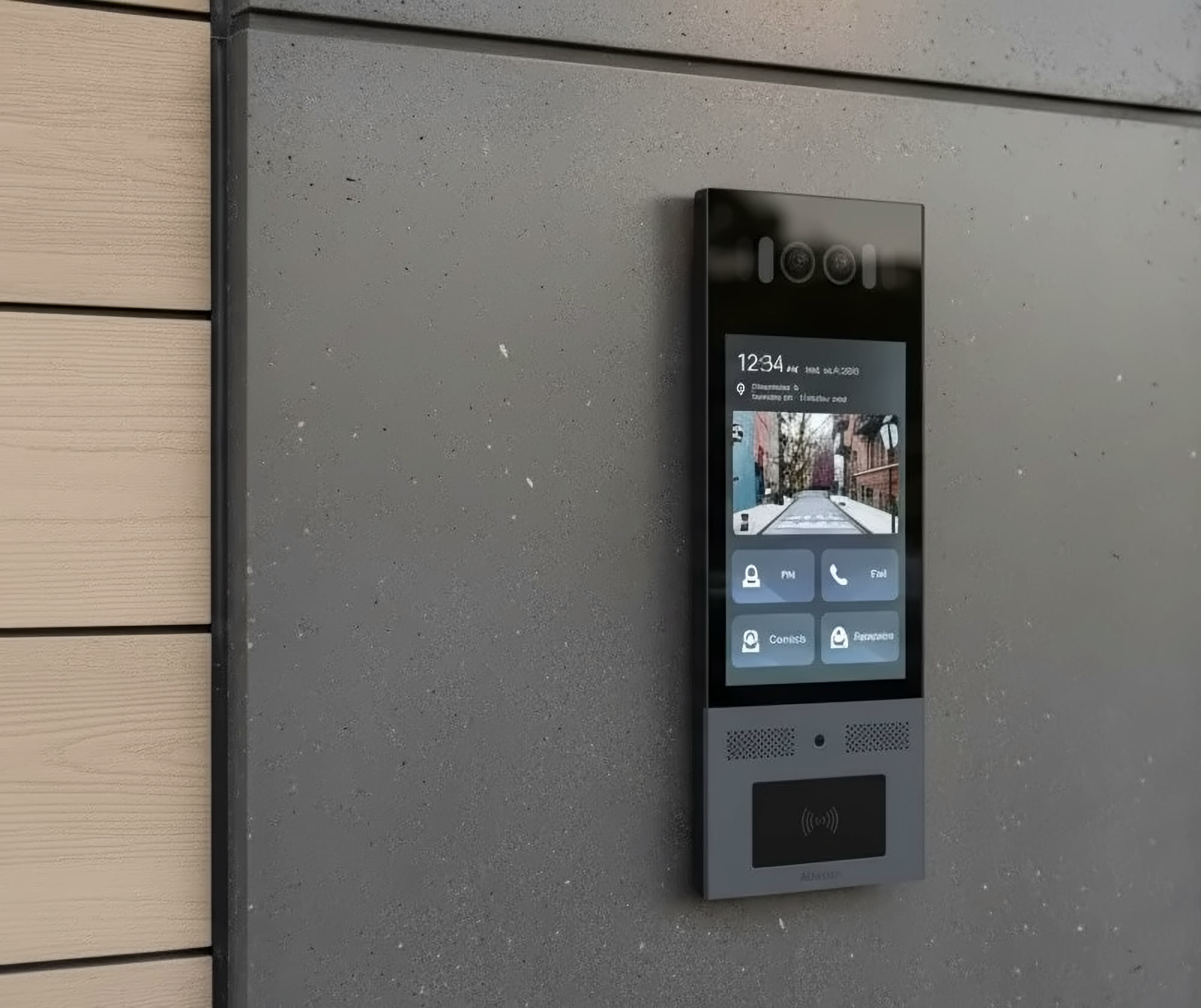 Video intercom with a touch screen, camera and card reader on a concrete wall beside glass entrance doors