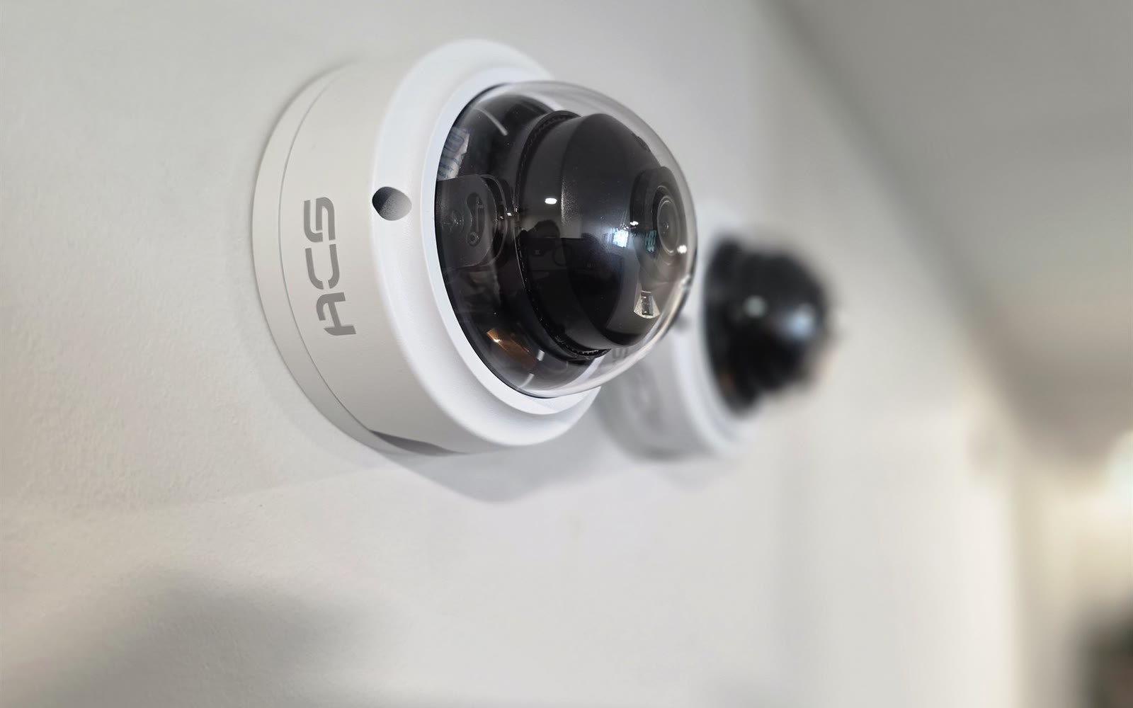 An ACS dome camera on an interior ceiling