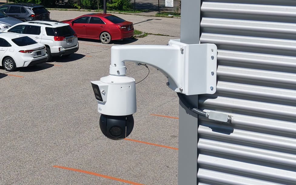 An ACS pan-tilt-zoom camera on a building above a parking area