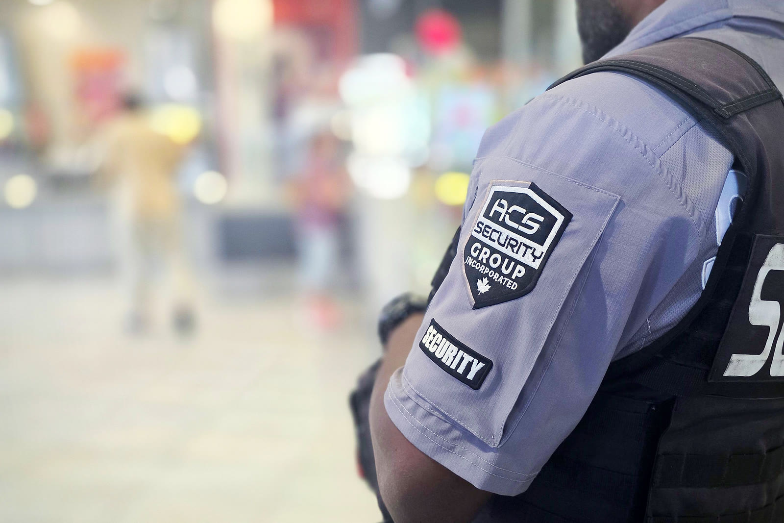 An ACS officer on the floor of a busy retail space
