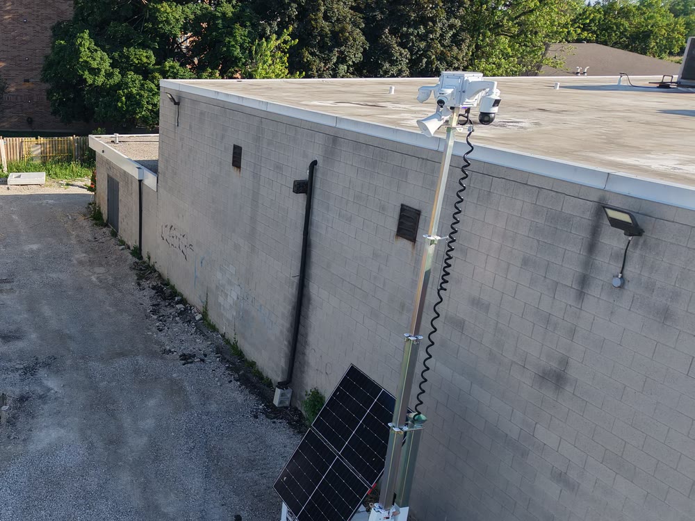 An ACS mobile tower on a paved lot, camera head at the top of a raised mast