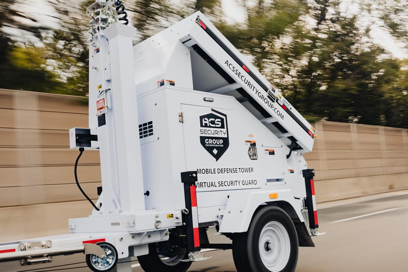 An ACS mobile tower being towed to a property