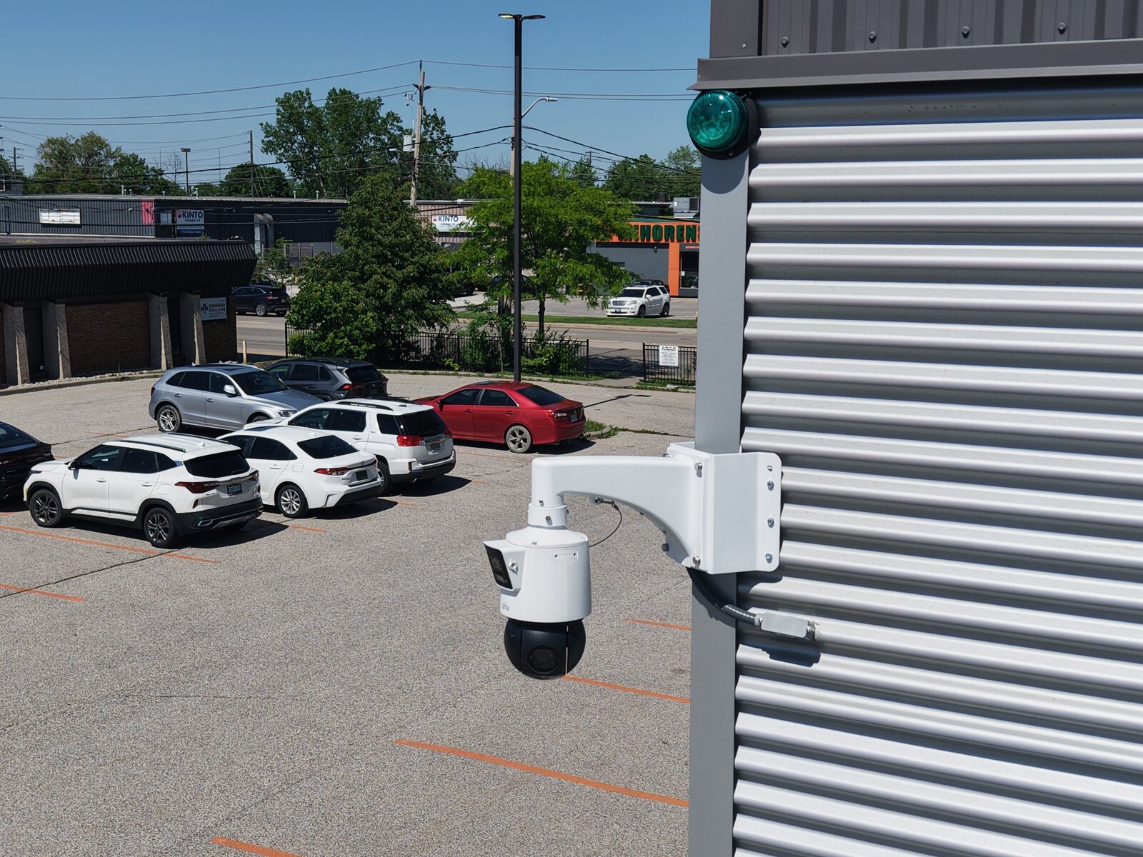 ACS pan-tilt-zoom camera overlooking a commercial parking lot full of vehicles