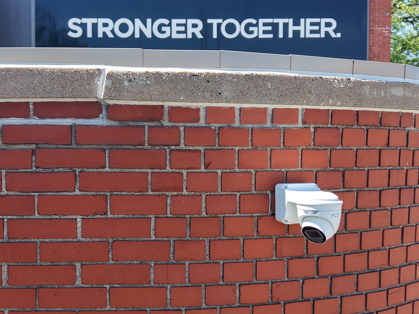 ACS dome camera mounted on a brick building