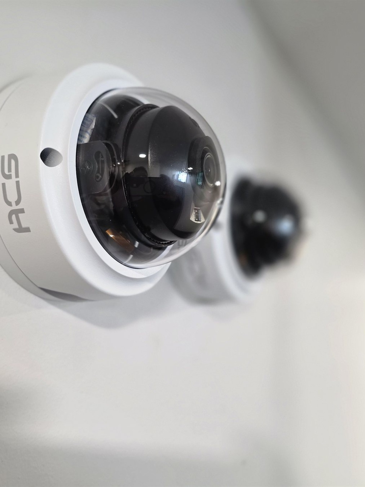 ACS AI dome security cameras mounted on a white wall