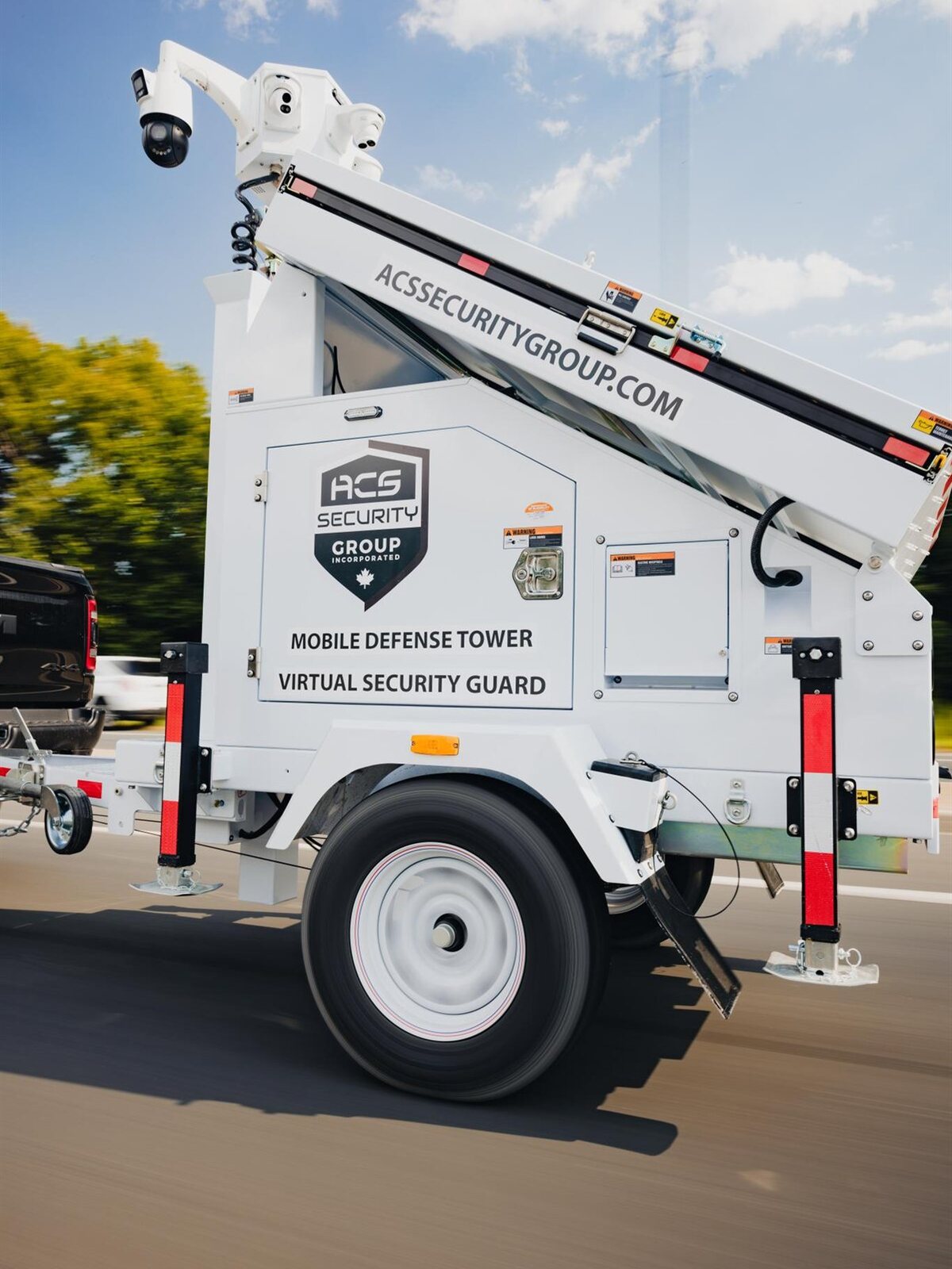ACS mobile security tower trailer being towed to a site