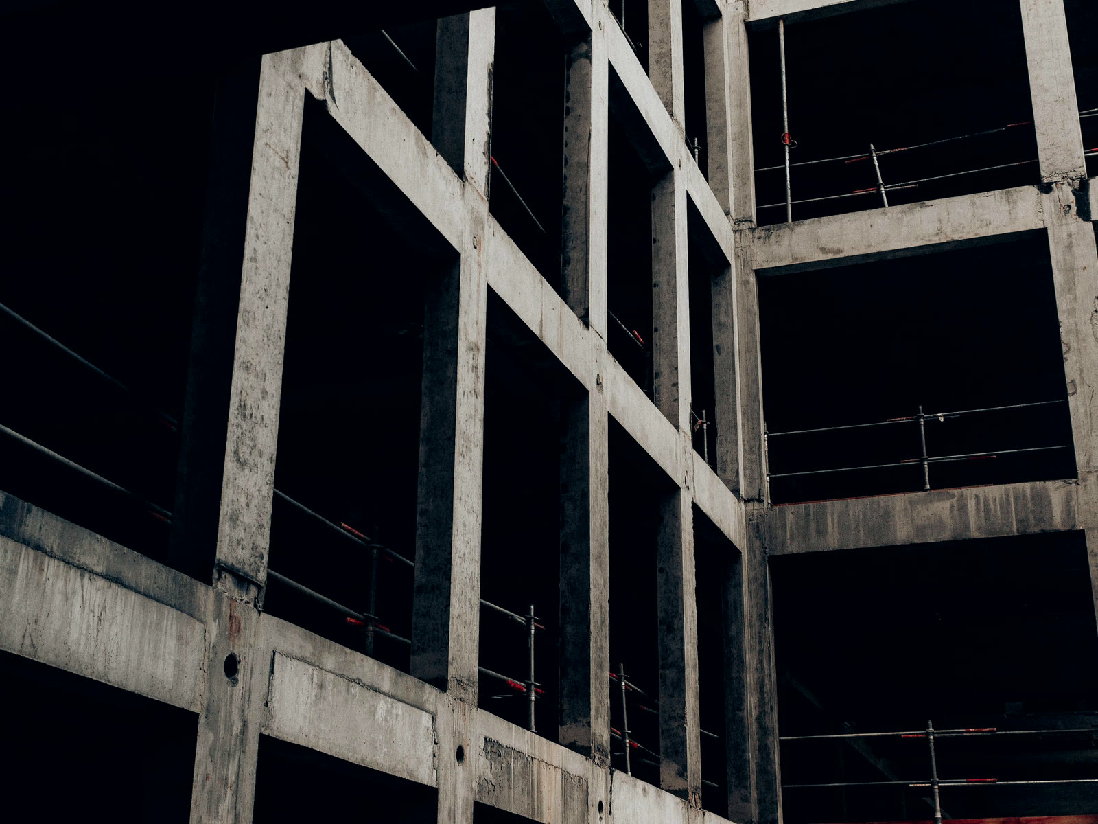 The concrete frame of a part-built building at night