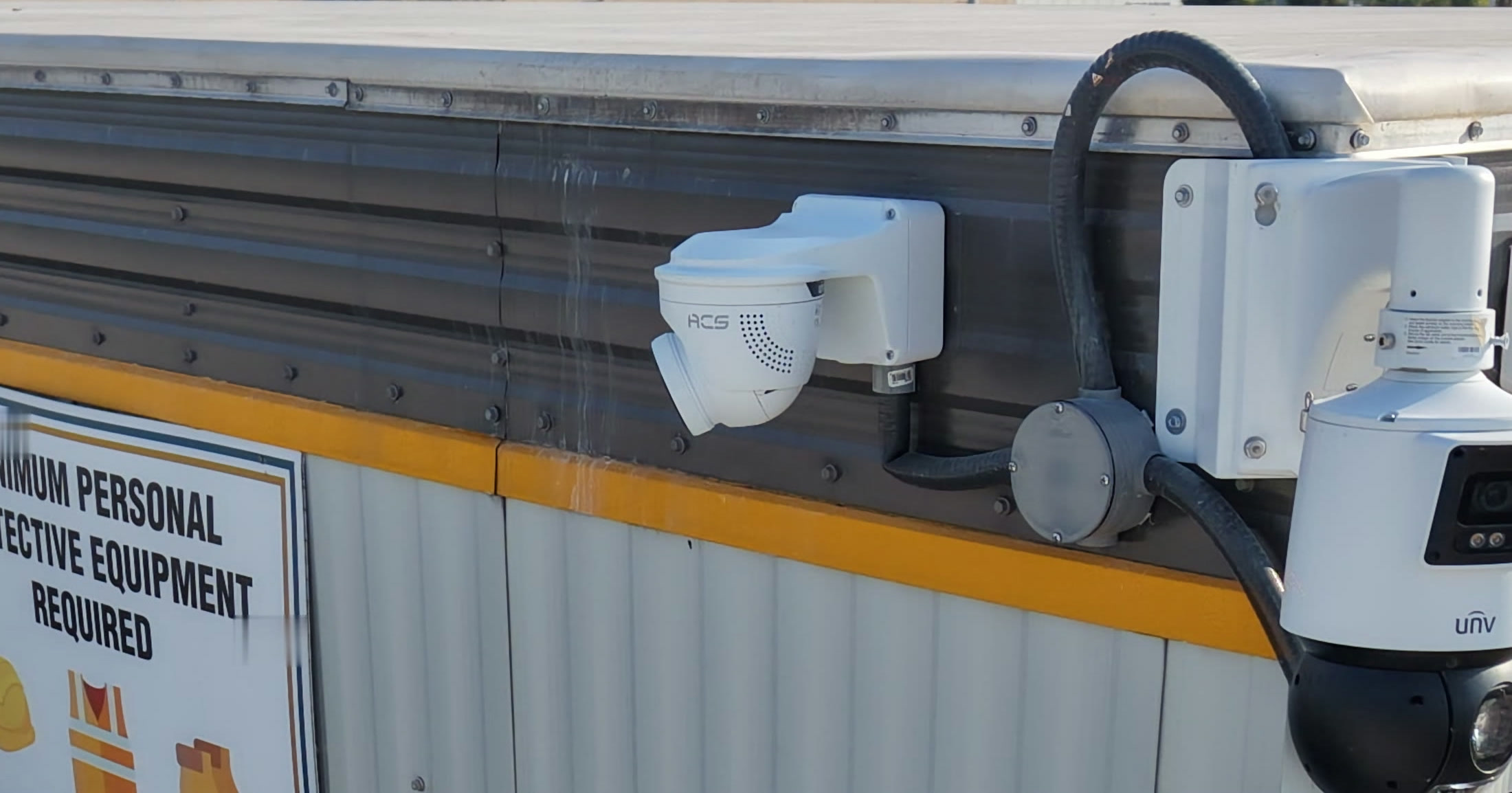 ACS cameras and a speaker mounted on the corner of a site office trailer