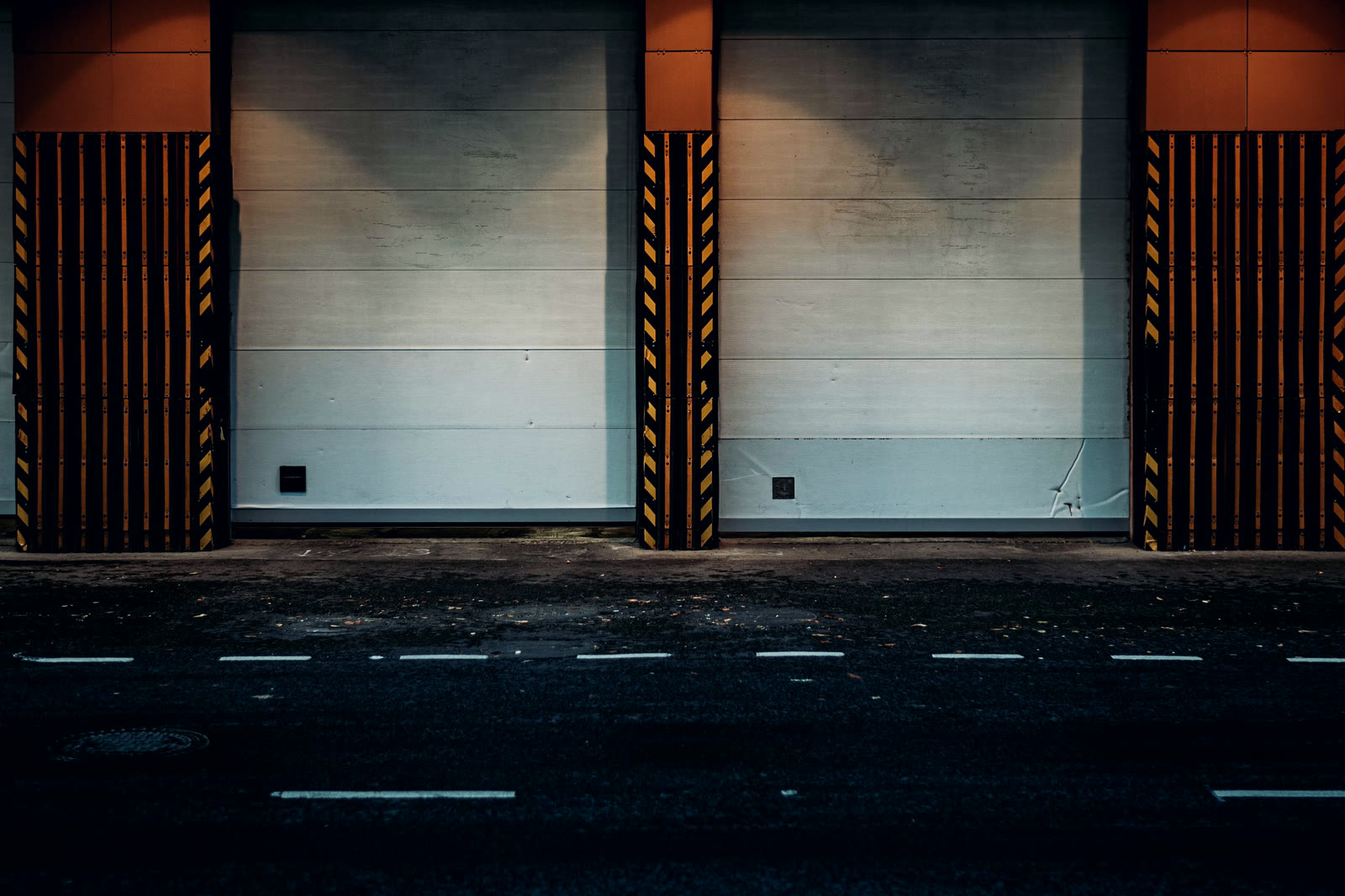 Loading dock doors at night with an empty apron in front of them