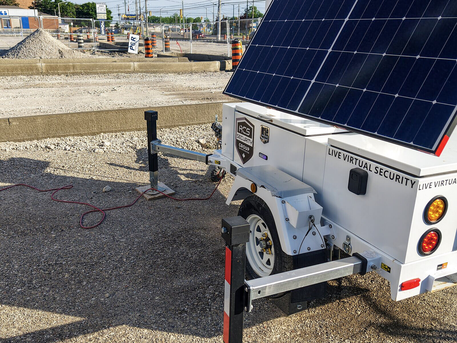 ACS mobile defense tower trailer with its solar panel raised on a gravel site