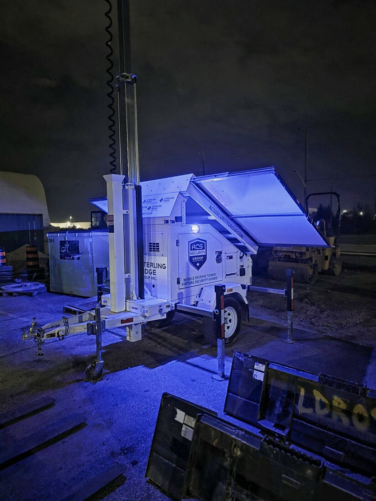 ACS defense tower lighting a construction site at night