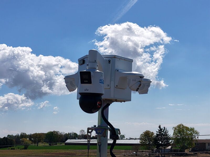 ACS tower camera head with PTZ and fixed lenses against open sky
