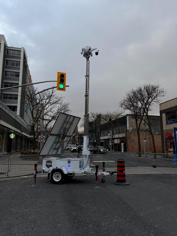 ACS mobile defense tower parked at a downtown intersection beside a traffic light