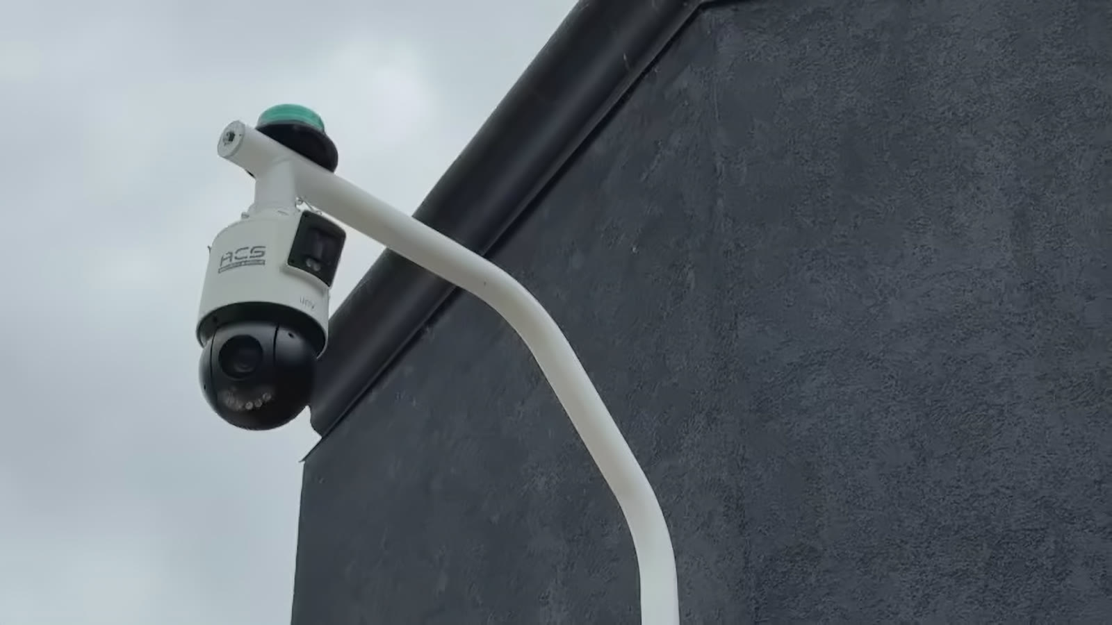 An ACS pan-tilt-zoom camera and strobe mounted on the corner of a commercial building